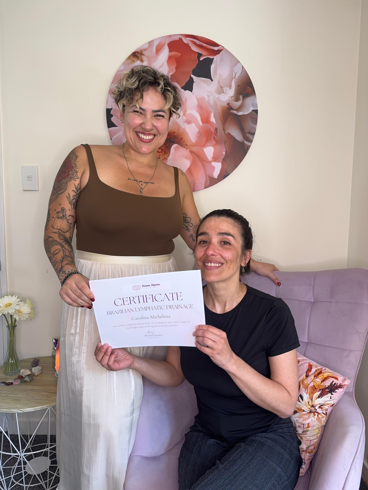 Student receiving her Brazilian Lymphatic Drainage certificate from Brunna